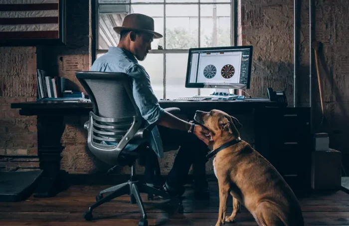 Service Dog owner in Washington state working at home with their service dog by their side.